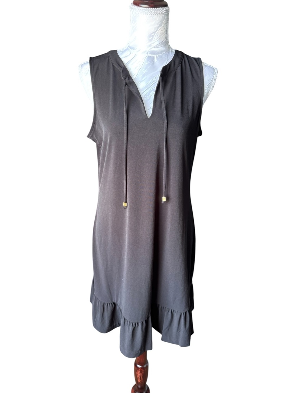 Michael Kors sleeveless shift dress featuring a ruffled hem and a tie front